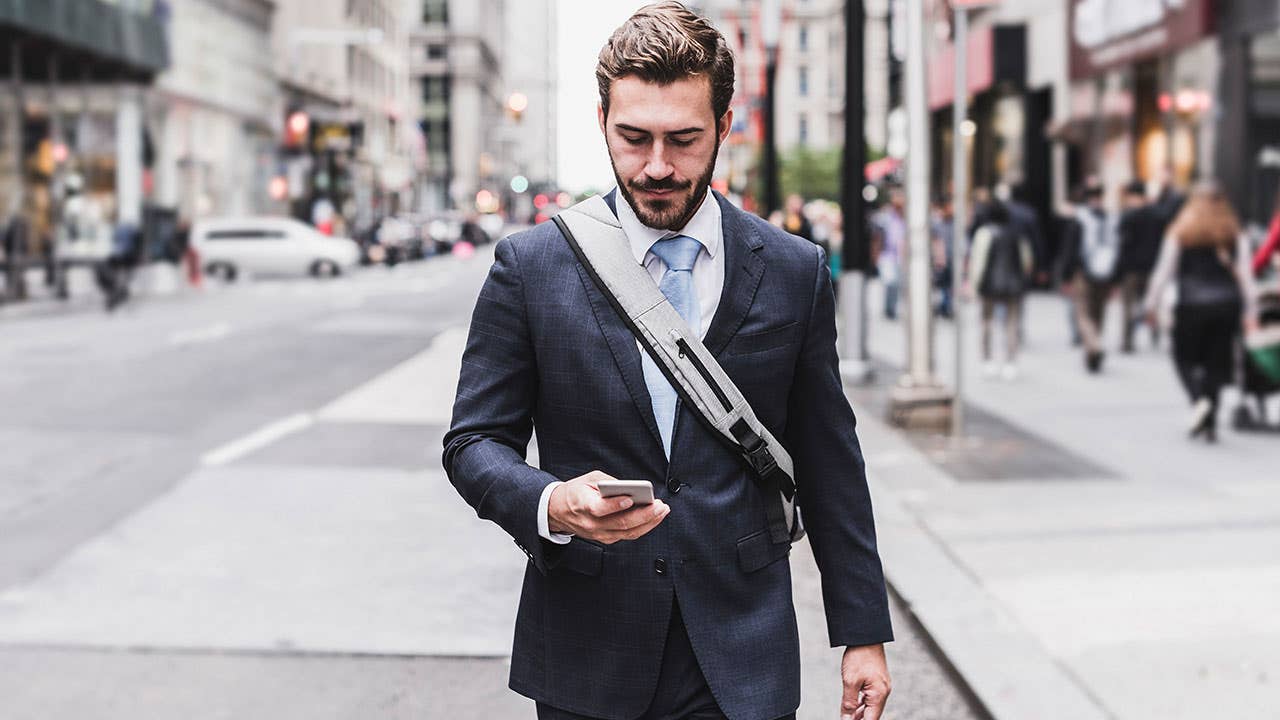 Man looking at phone in city