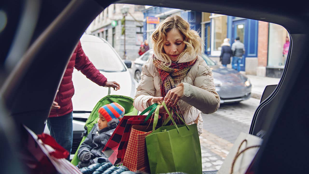 Mother loading car with holiday gifts