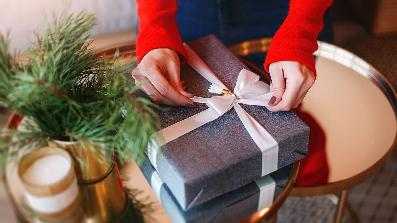 Woman tying a bow on gift