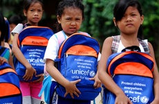 Kids receiving UNICEF backpacks