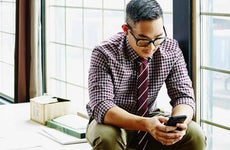 Professional young man working on smartphone in office