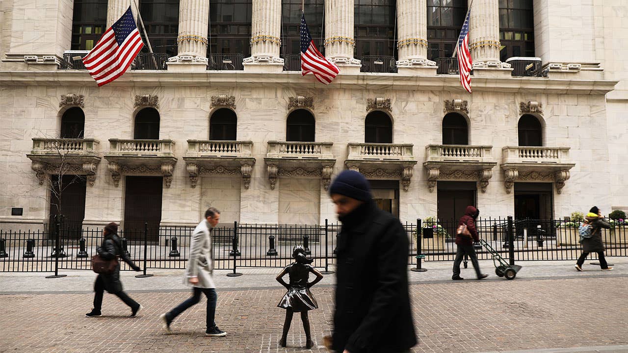 Pedestrians walking past the New York Stock Exchange