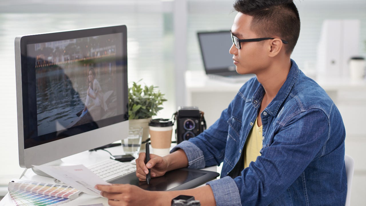 Designer retouching photo on his computer