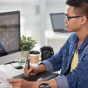 Designer retouching photo on his computer
