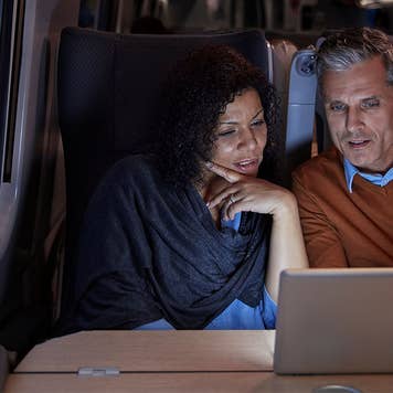 Couple on train looking at tablet
