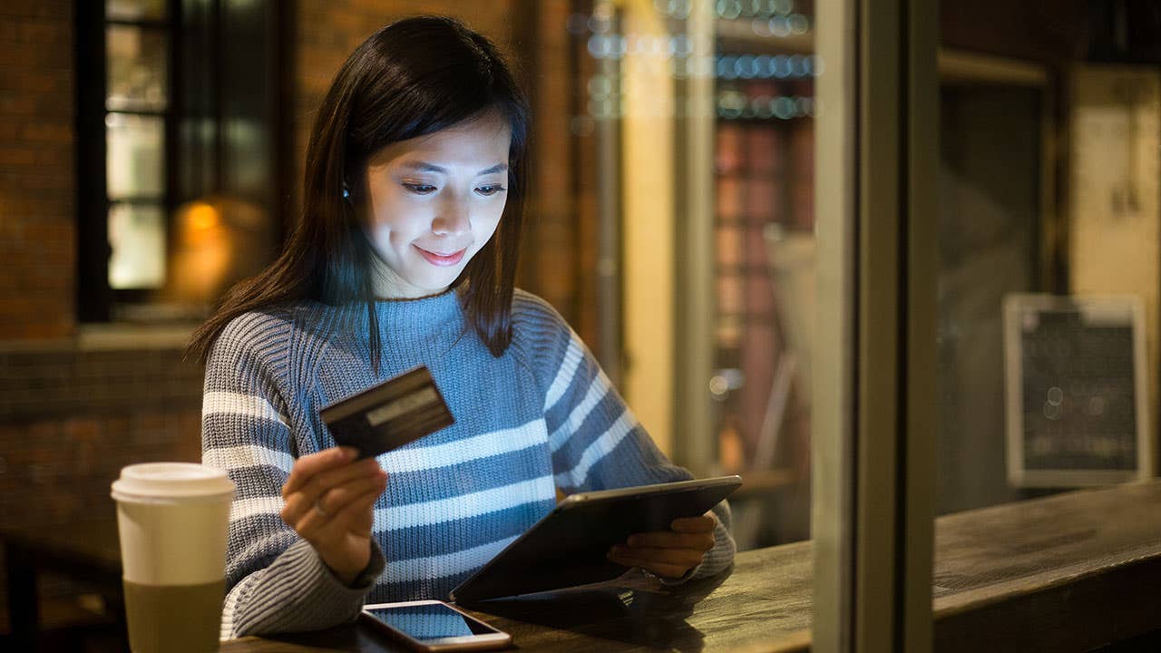 Woman paying with credit card on tablet