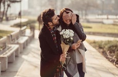 Man surprising girlfriend with flowers