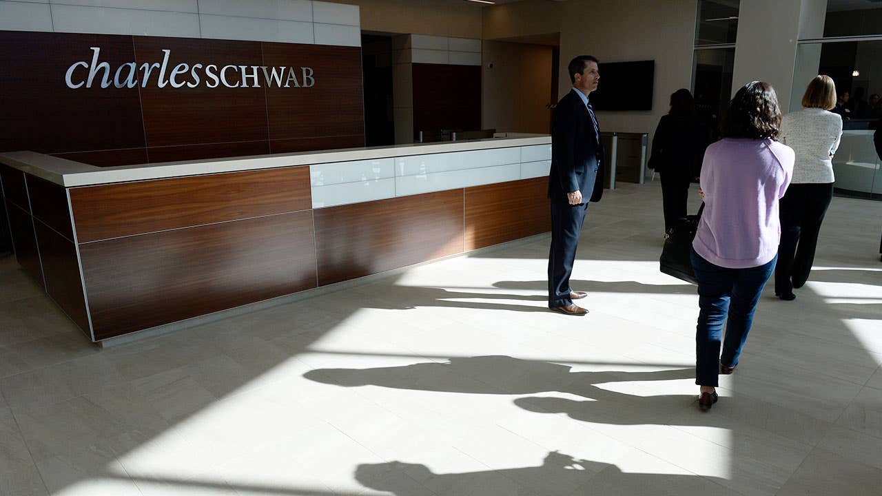 People walking into a Charles Schwab branch