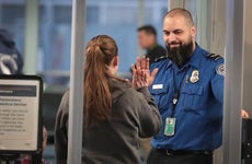 TSA worker high fives traveller