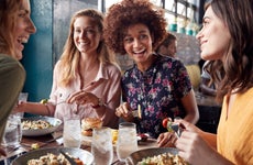 Four young women enjoying lunch at a restaurant
