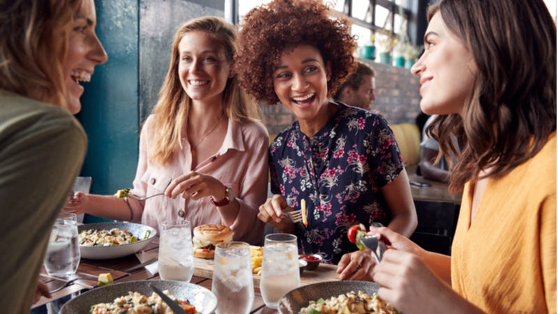 Four young women enjoying lunch at a restaurant