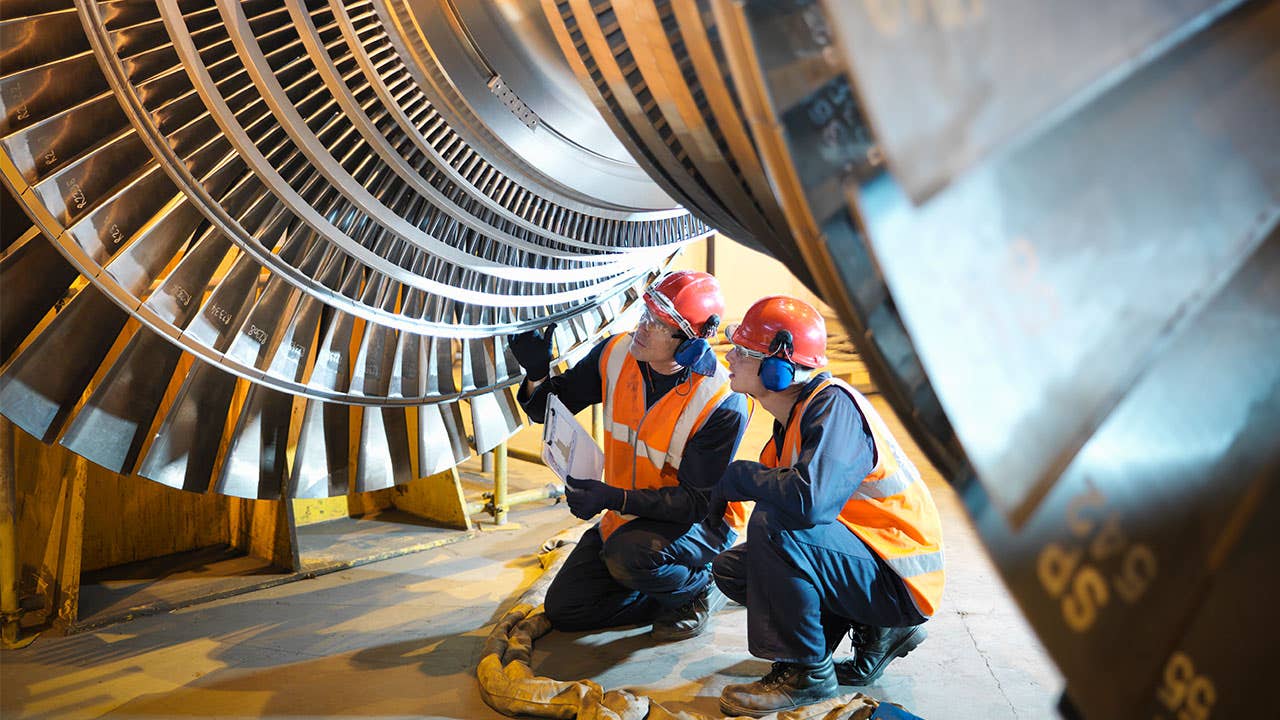 Manufacturing workers looking at a turbine