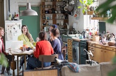 Young millennials talking in kitchen