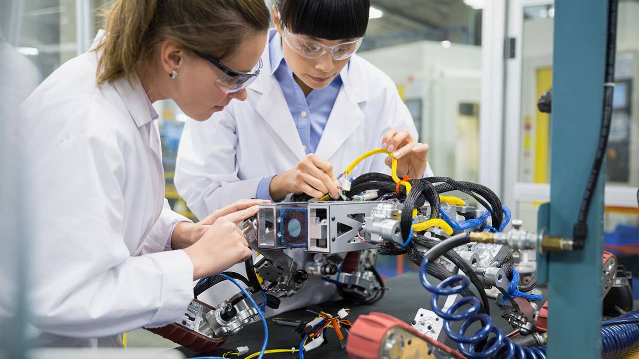 Scientists working on a robot in a lab