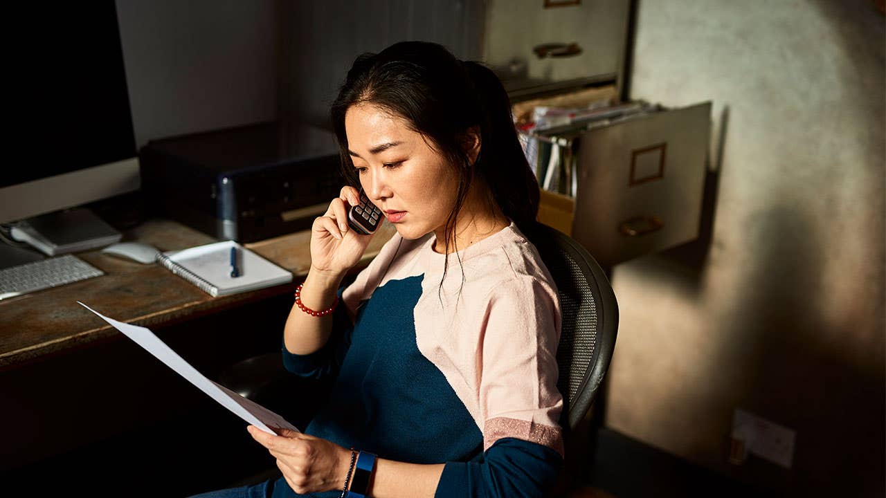 Woman talking on the phone with bank