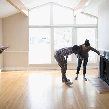 Couple inspecting a fireplace in a home walk through