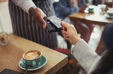 Person paying for coffee with card
