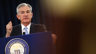 Fed cuts interest rates by a quarter point for the first time in a decade