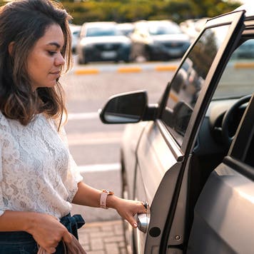 young woman getting into an SUV