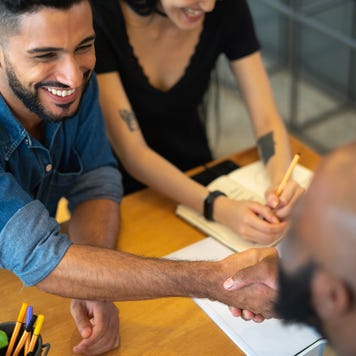 Couple shaking hands with an agent