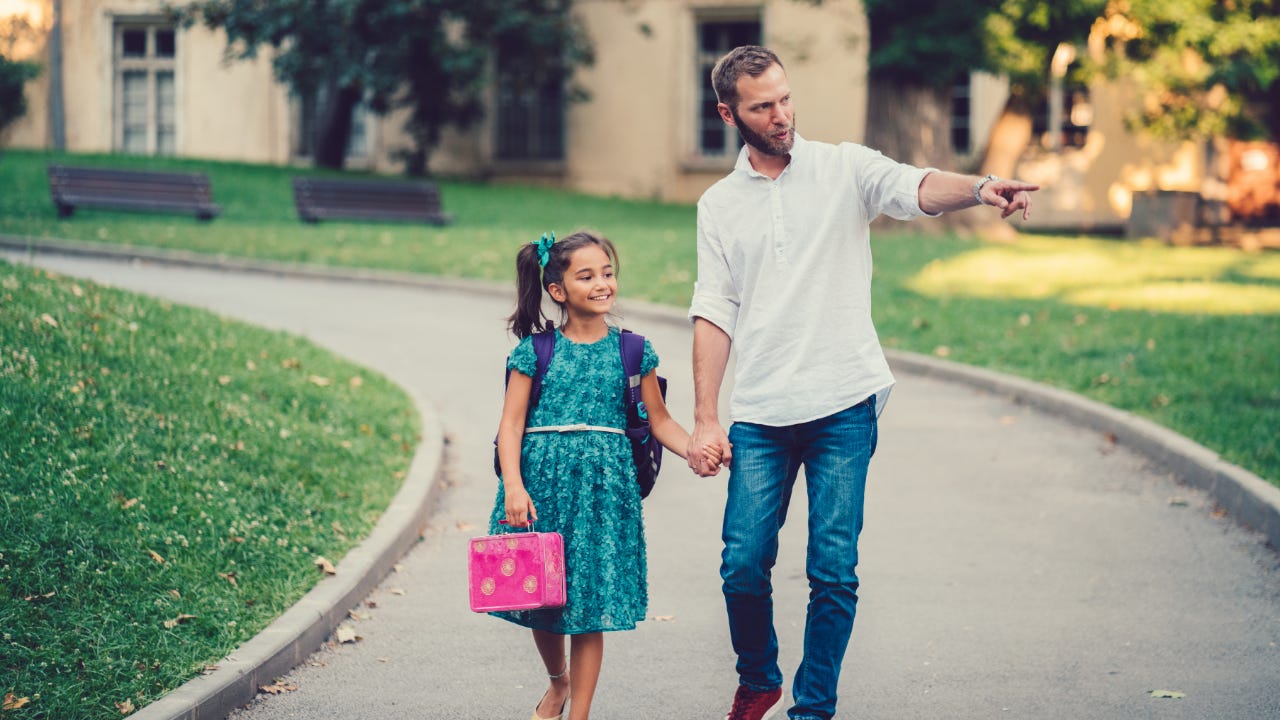 Father walking his daughter to school