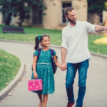 Father walking his daughter to school