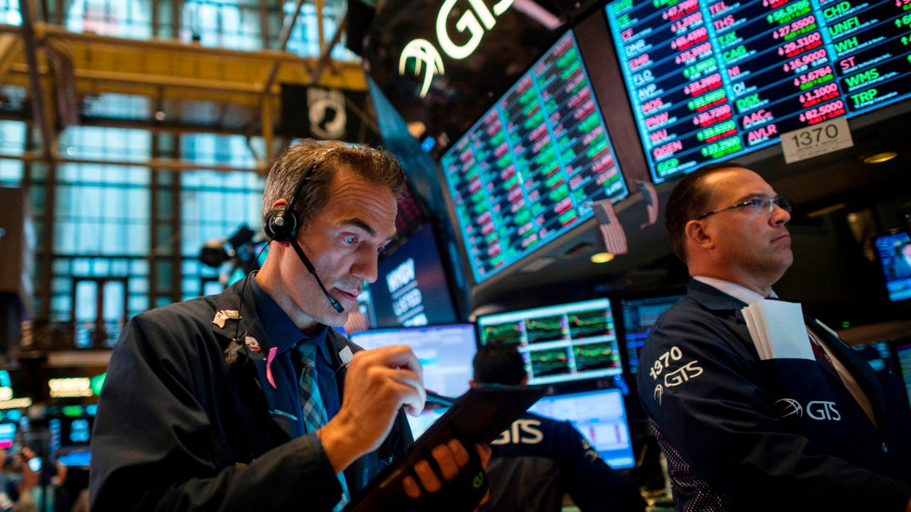 Traders work after the opening bell at the New York Stock Exchange