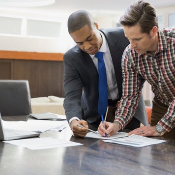 Couple signing financial paperwork