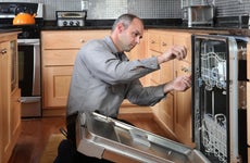 A technician fixing an appliance