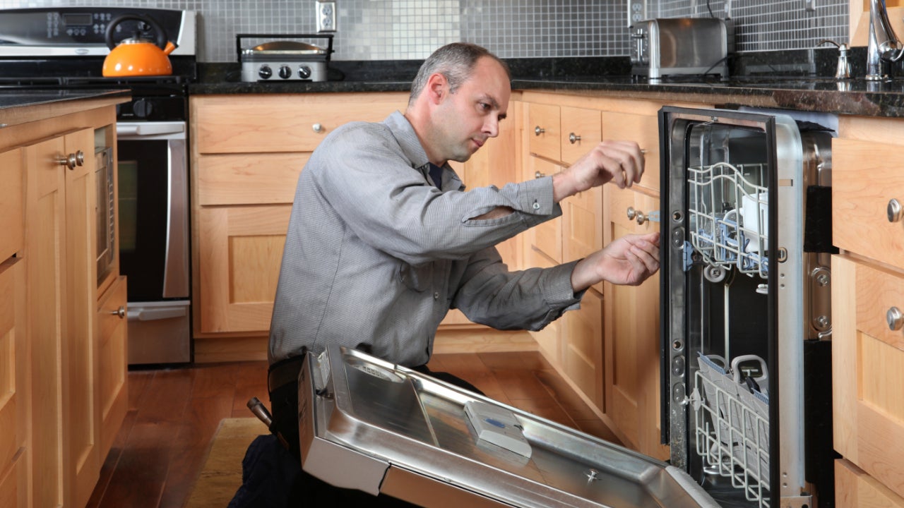 A technician fixing an appliance