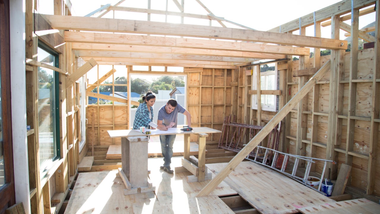 Couple working together to build themselves a new wood framed home.