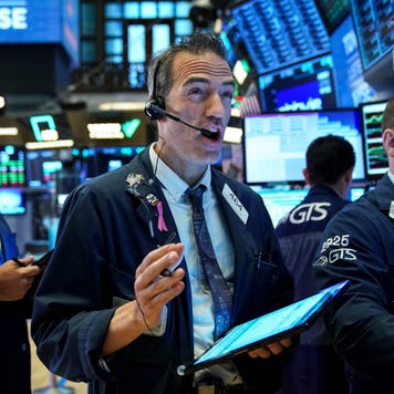 Traders on the floor of the New York Stock Exchange react to news