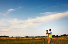A land surveyor conducts a land survey