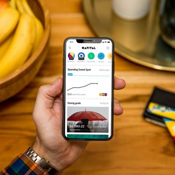 A man uses the Qapital app to save money.