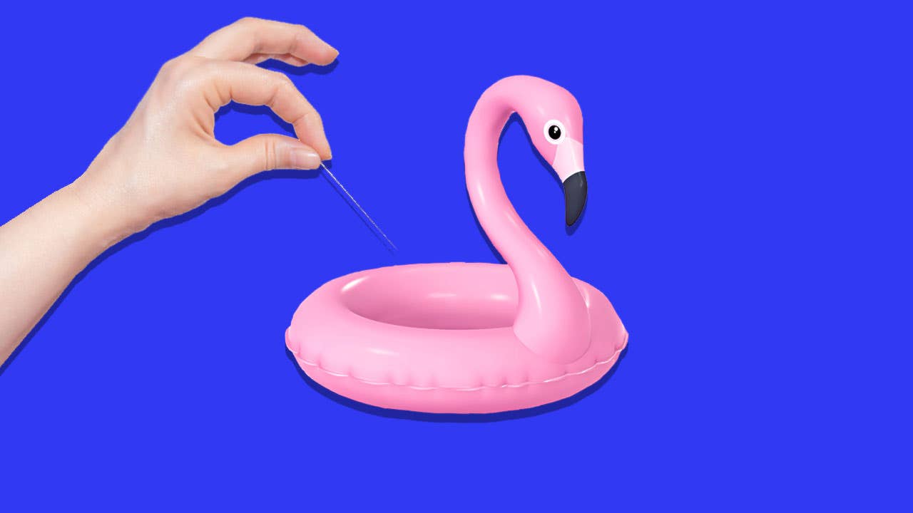 Woman with needle puncturing a flamingo floaty