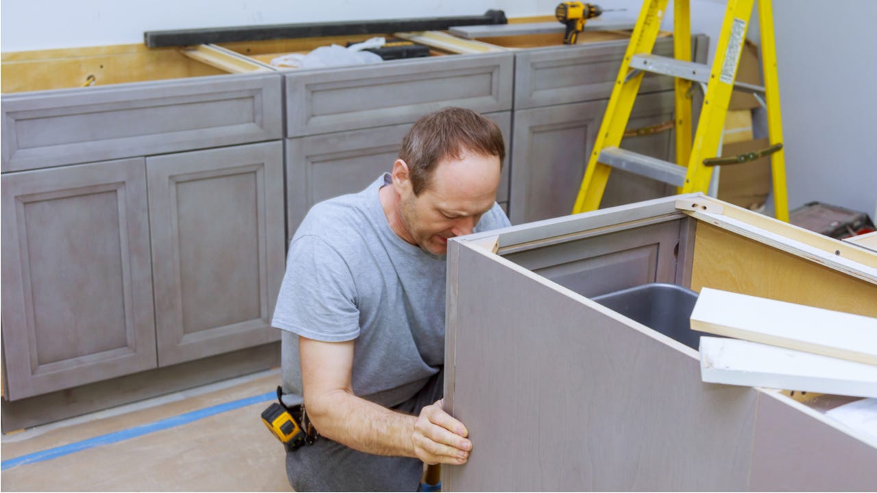 Man works on remodeling a kitchen