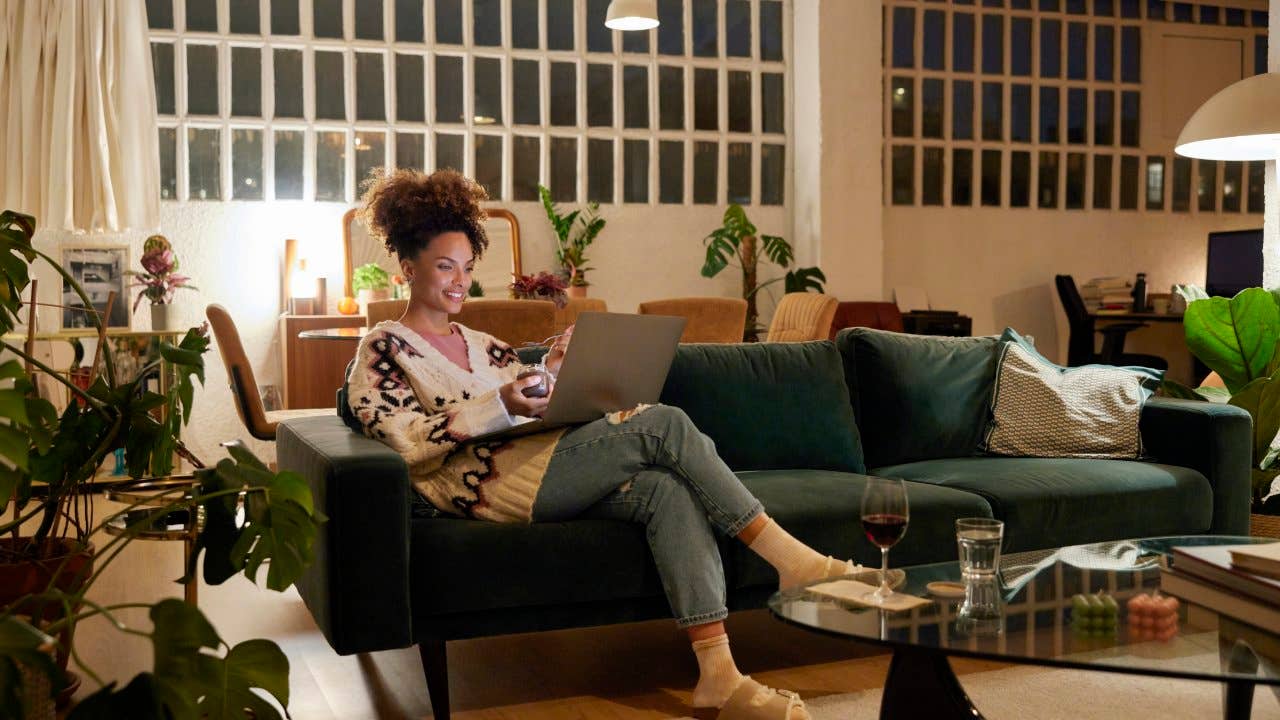 Woman using a laptop on a sofa