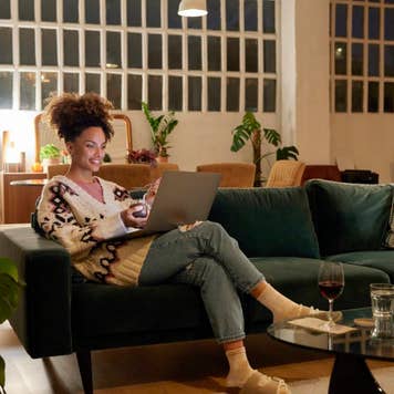 Woman using a laptop on a sofa
