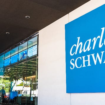 A picture of a Charles Schwab office and logo