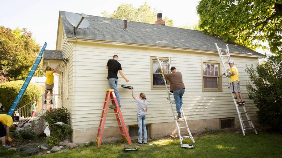 People painting the exterior of a house