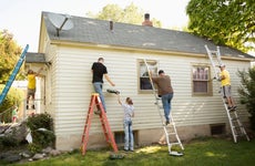 People painting the exterior of a house
