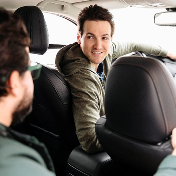 male driver talking to passenger