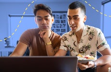 Gay couple looking up finances on computer