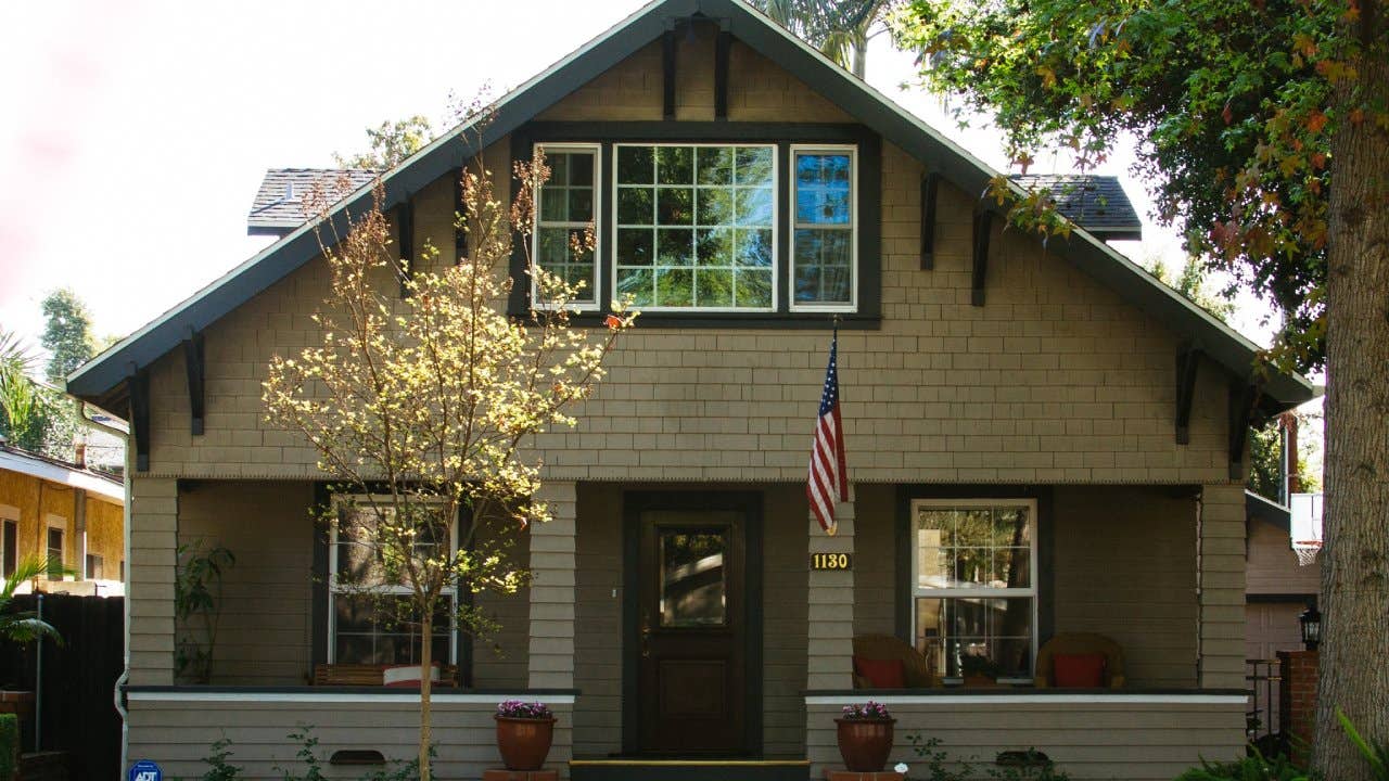 Bungalow home with an American flag hanging