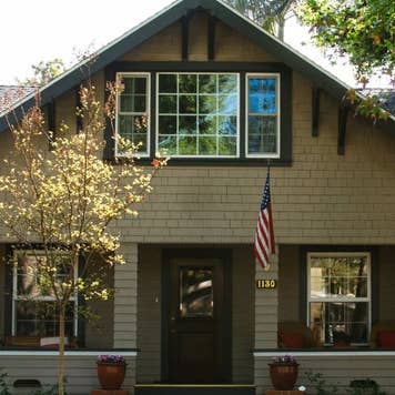 Bungalow home with an American flag hanging