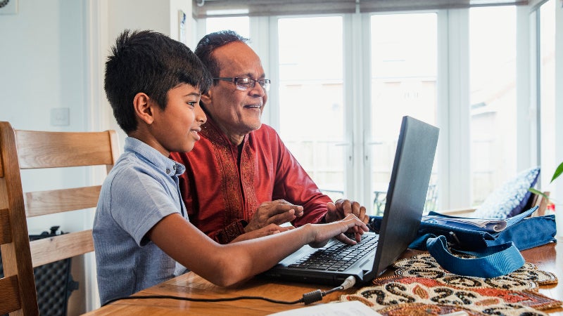 Grandfather and grandson on computer