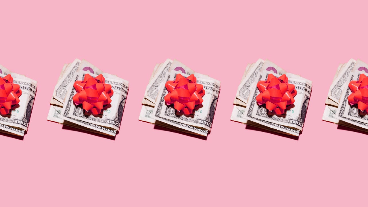 Row of folded dollar bills with red gift bows