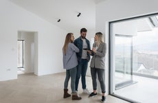 Real estate agent with couple in luxury home