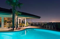 Illuminated pool at night with city in background, Los Angeles, California