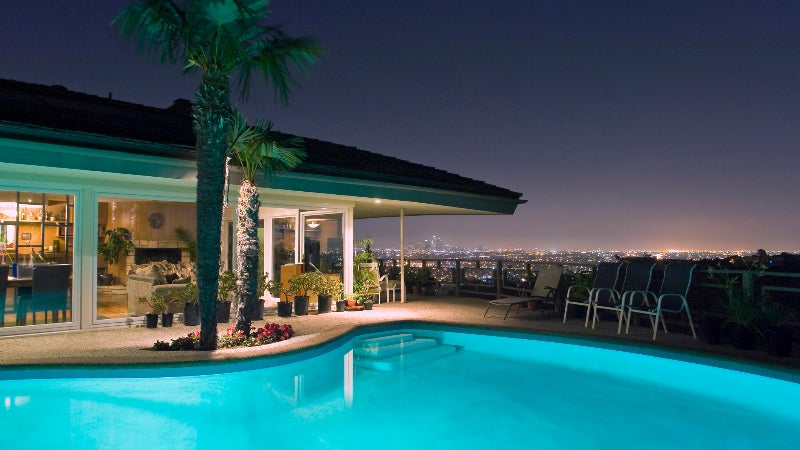 Illuminated pool at night with city in background, Los Angeles, California